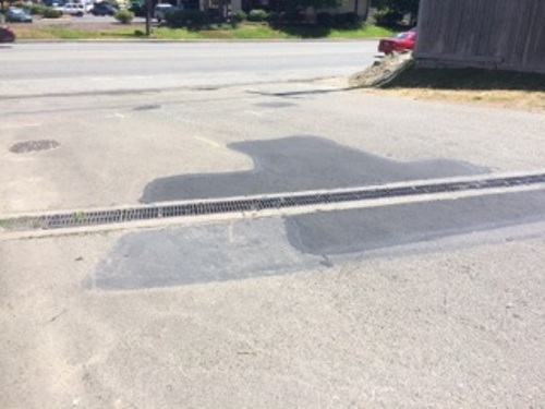 Asphalt patching near a parking lot drain